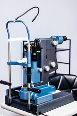 Slit lamp ophthalmology equipment on examination table, showcasing intricate design and functionality in a clinical setting for vision assessment and eye health evaluation