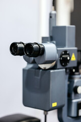 Slit lamp device used in ophthalmology for detailed vision examination, showcasing advanced optics and precision engineering in a clinical setting with copy space