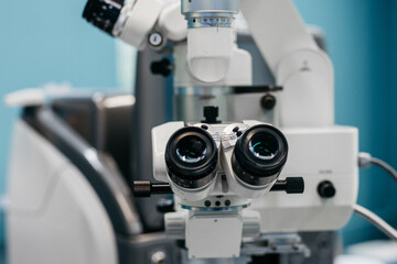 Ophthalmology microscope with dual lenses positioned in a clinical setting, showcasing advanced technology for vision examination and laser vision correction procedures