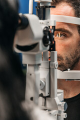 A male patient undergoes a detailed slit lamp eye examination, demonstrating advanced ophthalmology equipment.