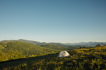 Tourist tent in the mountains at sunrise