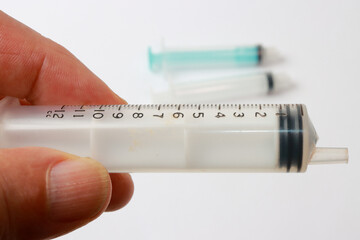 Man holding a 12cc Medical Syringe in his hand