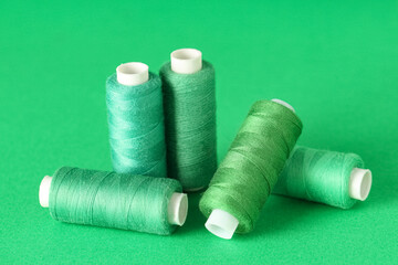 Spools of thread on green background