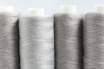 Spools of thread on grey background, closeup