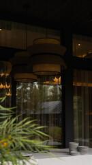 cozy terrace in the restaurant on the street. warm atmosphere, wicker chandelier, panoramic windows