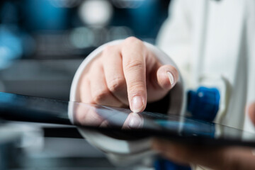 Close up of astronaut using tablet to confirm suit integrity, verifying mission parameters. Orbital station crew member testing gear during routine equipment check, troubleshooting hardware