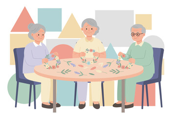 Seniors happily crafting floral wreaths together enjoying a leisurely and creative activity