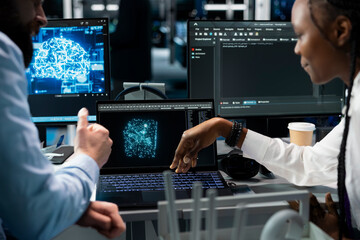 Lead programmer and female engineer in data center updating AI automation scripts. Server room IT expert and african american woman programming artificial intelligence algorithms at desk