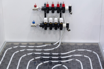 Underfloor heating system and collector at the exhibition stand