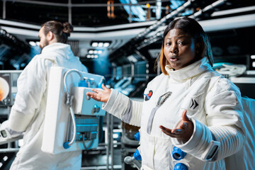 Astronaut doing video briefing with Earth based scientists team while orbiting in space station. Starship crew member presents current mission status during remote videocall