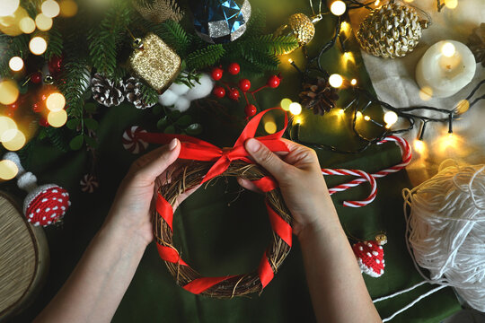 Merry Christmas. New year's toys in hand. DIY Christmas wreath to decorate the Christmas tree. DIY toys. Holiday with children. Cozy home on Christmas eve.