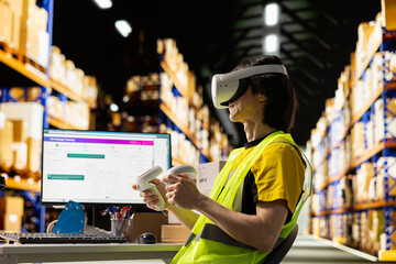 Asian man in hi vis vest working with VR tech system to process orders and manage parcel shipment...