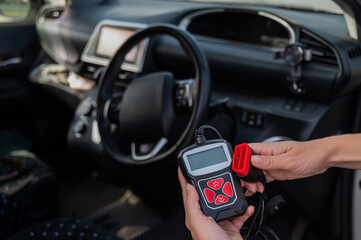 Woman using OBD2 diagnostic scanner. 