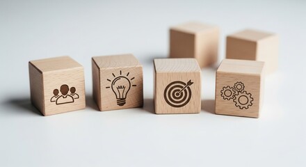 Obraz premium Wooden blocks with icons representing teamwork, innovation, and strategy.
