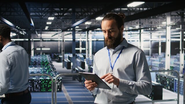 Computer scientists in data center monitoring neural network LLM visualization. Industrial; server farm IT professionals overseeing rigs powering machine learning processes,