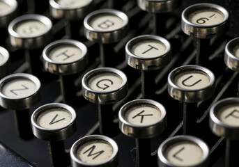 Close-up of typewriter keys with letters and numbers. A detailed shot showcasing vintage technology and design.. Historical artifact, writing instrument, analog tool.