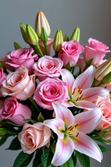 Obraz premium Delicate pink roses and lilies arranged in a charming bouquet. Soft pastel tones, lush petals, and vibrant blooms create a romantic and elegant floral display, wedding, flower arrangement