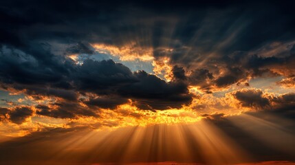 Golden sunlight pierces dark clouds creating a stunning sunset scene over the horizon.