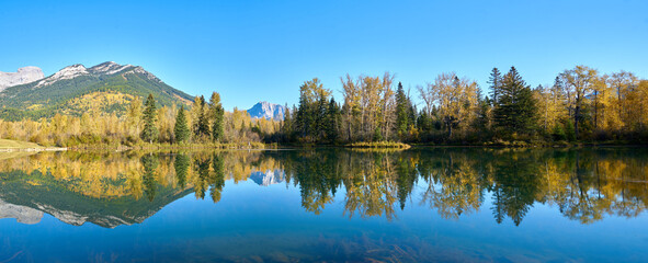 Maiden Lake Reflection Fernie British Columbia. A still, sunny day at Maiden Lake in Fernie BC in the Rocky Mountains.
