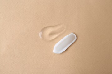 Samples of cosmetic products on beige background, top view