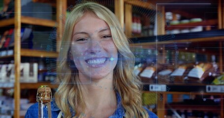 Denim-clad woman getting face scan using digital overlay in deli, with wine bottle, wooden shelves