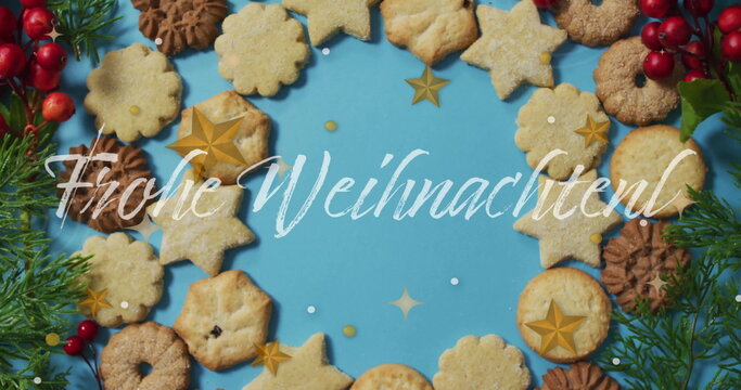 Naklejki Frohe Weihnachten text image over assorted Christmas cookies on blue background