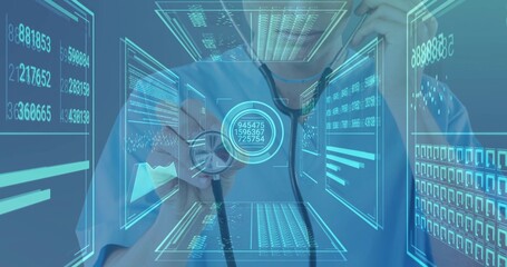 Doctor wearing scrubs examining patient metrics on data panels in clinic, with stethoscope in hand