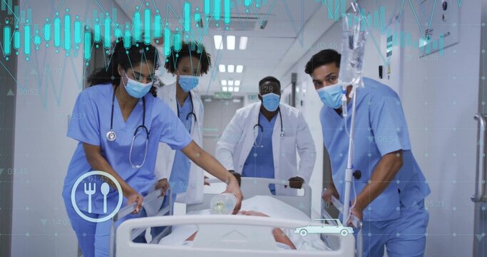 Moving medical team in blue scrubs guiding patient on gurney down hospital corridor, with Ambu bag
