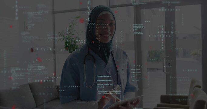 Displaying stethoscope and overlay, nurse wearing teal scrubs and headscarf holding tablet in lobby - Powered by Adobe