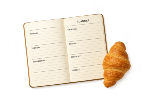 Weekly planner notebook with croissant for breakfast planning