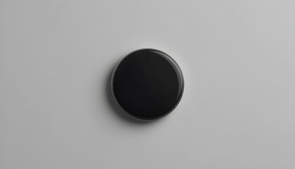 Sleek black circular button for modern interfaces and minimalist designs, perfect for UI elements and technology concepts on clean white background