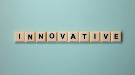 INNOVATIVE word with alphabet cubes isolated on Light Blue Background