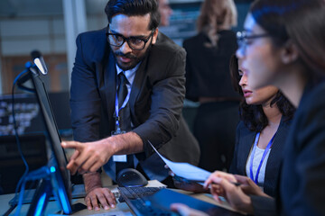 A senior manager provides one-on-one training to a smiling junior female employee in a modern office, fostering a supportive environment for professional growth and skill development.
