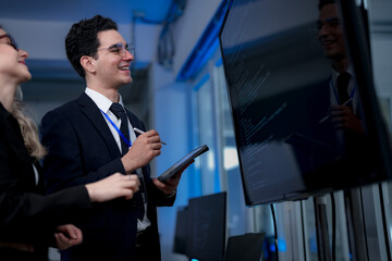 A quantum computing scientist explains a complex algorithm to a colleague, pointing to the code...