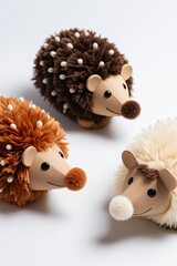 Three hedgehog-shaped plush toys with rust, dark brown, and cream fur, cardboard-like snouts and eyes, on white background, photo-realistic texture