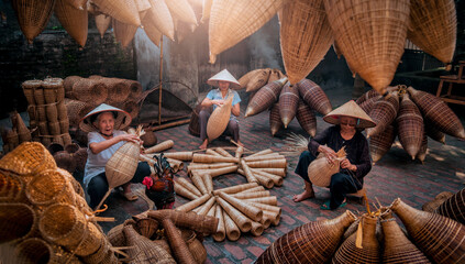 Vietnamese fishermen are doing basketry for fishing equipment at morning in Thu Sy Village, Vietnam.