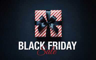 A minimalist promotional image for a Black Friday sale. The image features a wrapped gift box with red and white diagonal striped wrapping paper and a black satin bow on top. 