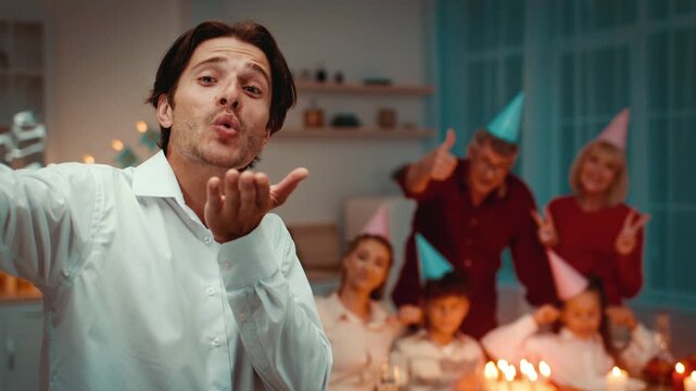 A joyful family celebrates Birthday at home, enjoying each other's company. They share laughter and partake in festive activities, creating cherished memories together.