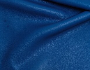 Fototapeta premium A rich, textured blue leather background featuring subtle grain patterns and a soft sheen, perfect for adding elegance to any design project.
