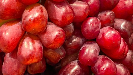 A close-up of ripe Red Globe grapes. The berries are large, with firm skin and sweet, crisp flesh. Concept: freshness, natural food, fruit, healthy eating.