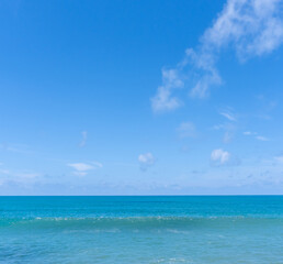 Deep blue sea and wave with blue sky and thin fluffy clouds taken at the sea in Phuket South of Thailand used as blue natural background texture