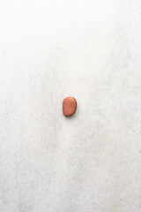 Overhead view of kola nut on white granite countertop, top view of fresh kolanut often used for religious ceremonies in african communities