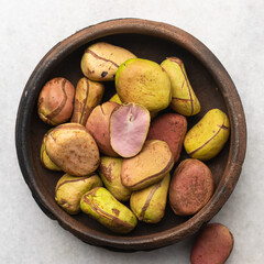 Overhead view of kola nut in clay bowl, top view of kolanut seed
