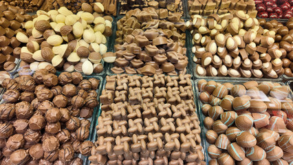 Various types of chocolates arranged neatly in a glass display case