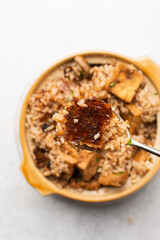 Overhead view vegan claypot rice on a marble countertop