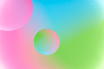 Vibrant Abstract Macro Background with Floating Oil Droplets in Pink, Cyan, and Lime Green Fluid