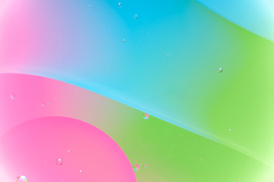 Pink, Cyan, and Green Fluid Abstract Macro Background with Oil Bubbles