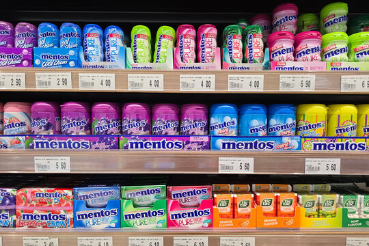 Penang, Malaysia &ndash; Oct 14, 2025: Colorful display of assorted Mentos and Tic Tac candies arranged neatly on a supermarket shelf.