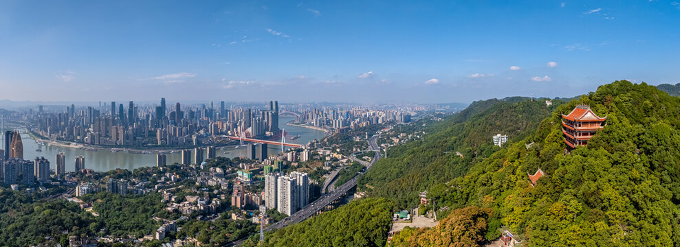Scenic view from Nanshan, showing a traditional Chinese pagoda nestled in green forest, contrasting with the sprawling modern skyline of Chongqing, China, in the background. A blend of old and new.