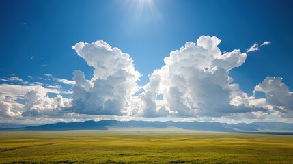 Aerial view of clouds casting shadows over vast open fields, evoking simplicity and elegance